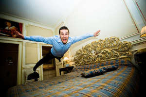 Homem voando sobre a cama